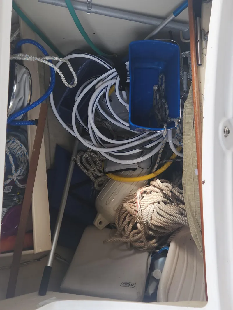 Slide: The Image of Storage compartment of a 2004 Hunter 36 sailboat with ropes and equipment. - 7