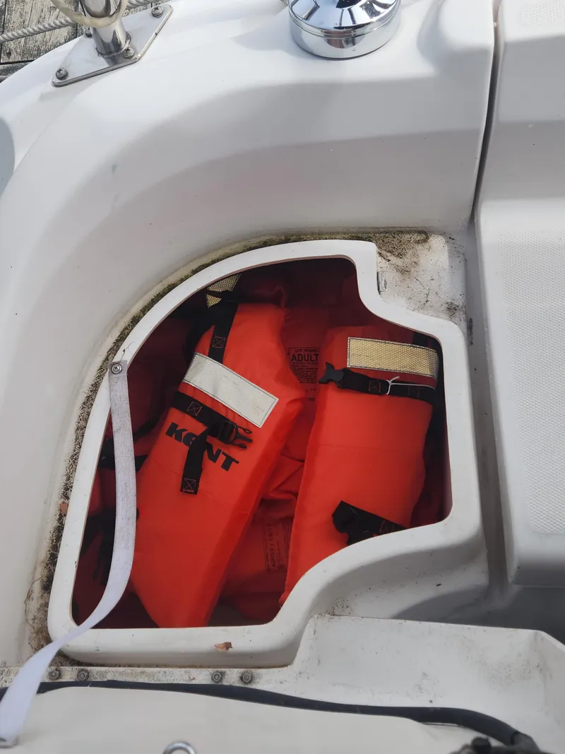 Slide: The Image of Storage compartment on a 2004 Hunter 36 boat with orange life jackets. - 9