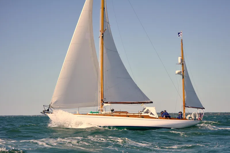The Image of Classic 1964 Concordia 39 sailboat navigating ocean waves under clear skies. - 0