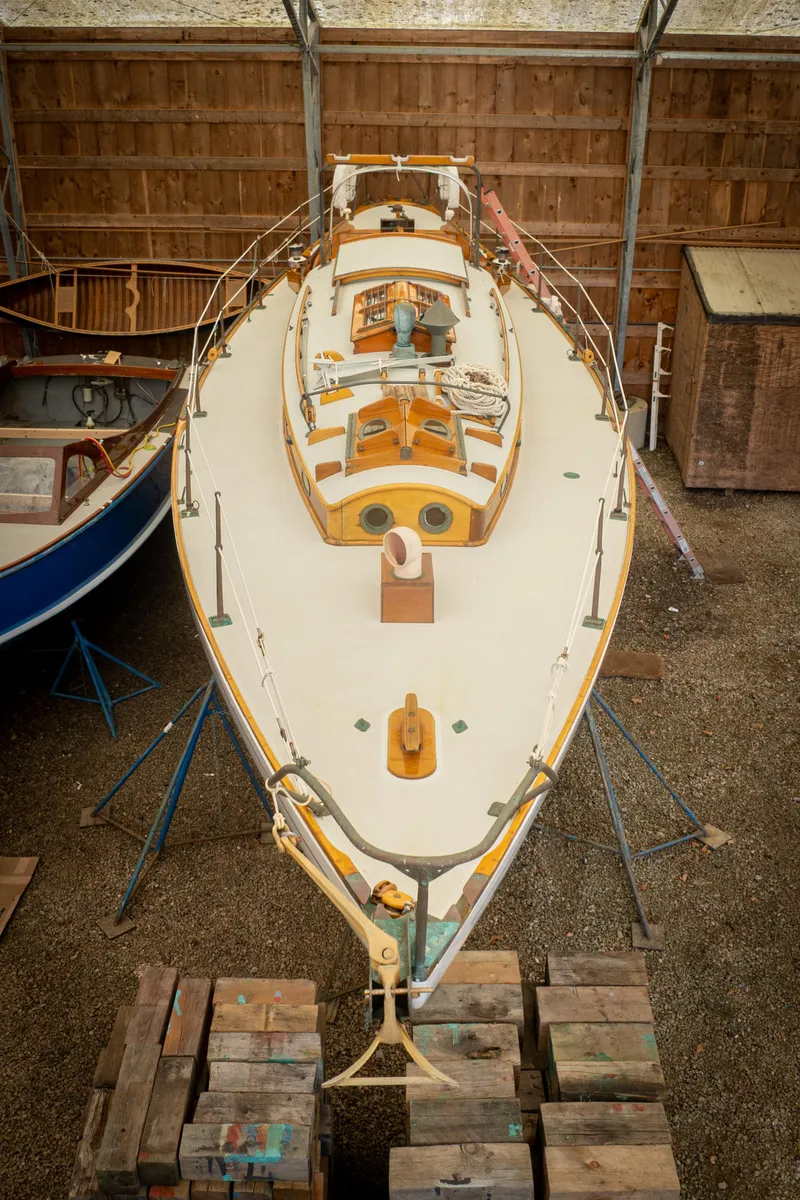 Slide: The Image of 1964 Concordia 39 sailboat in storage, viewed from above, showcasing classic design and craftsmanship. - 12