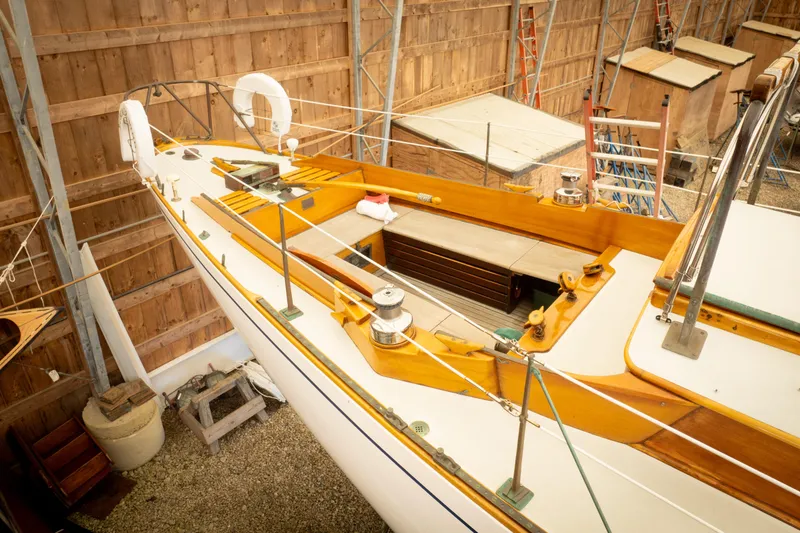 Slide: The Image of 1964 Concordia 39 sailboat in wooden shed, showcasing deck and rigging details. - 15