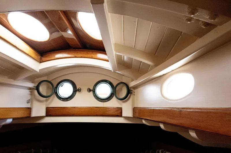 Slide: The Image of Interior of 1964 Concordia 39 sailboat with wooden beams and portholes. - 19