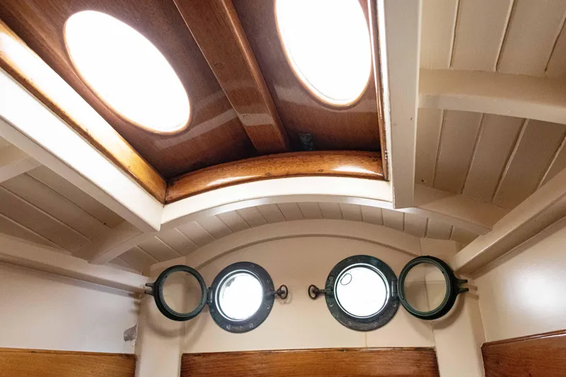 Slide: The Image of Interior of 1964 Concordia 39 sailboat with wooden ceiling and round portholes. - 22