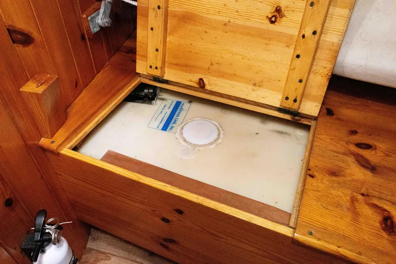 Slide: The Image of Wooden storage compartment on a 1964 Concordia 39 boat, revealing interior details. - 25