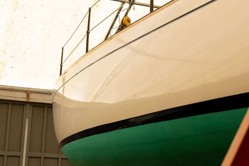 Slide: The Image of 1964 Concordia 39 sailboat in storage, showcasing its sleek hull design. - 28