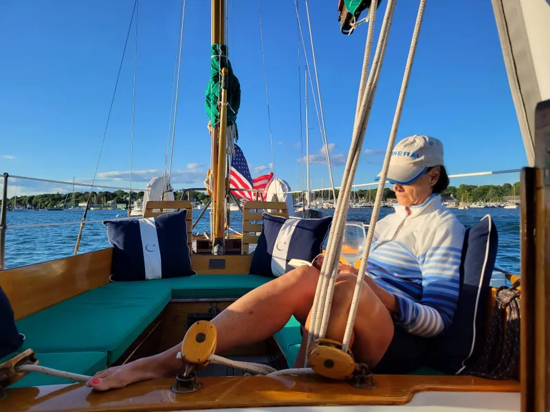 Slide: The Image of Woman relaxing on a 1964 Concordia 39 sailboat, enjoying a sunny day on the water. - 42