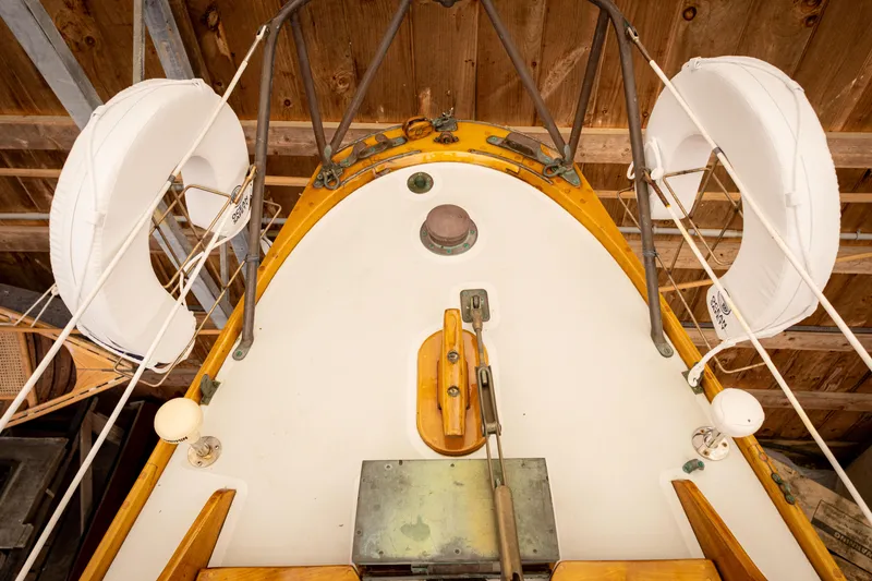 Slide: The Image of 1964 Concordia 39 sailboat deck with life rings and wooden accents in a boathouse. - 44