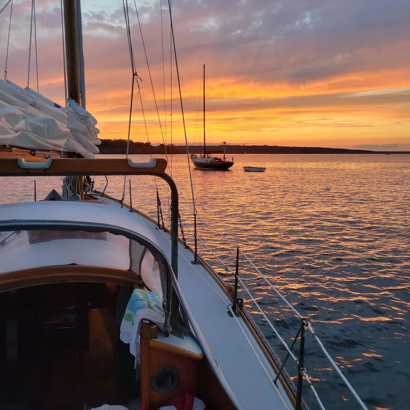 Slide: The Image of Sailboat Concordia 39, 1964 model, at sunset on tranquil waters. - 47