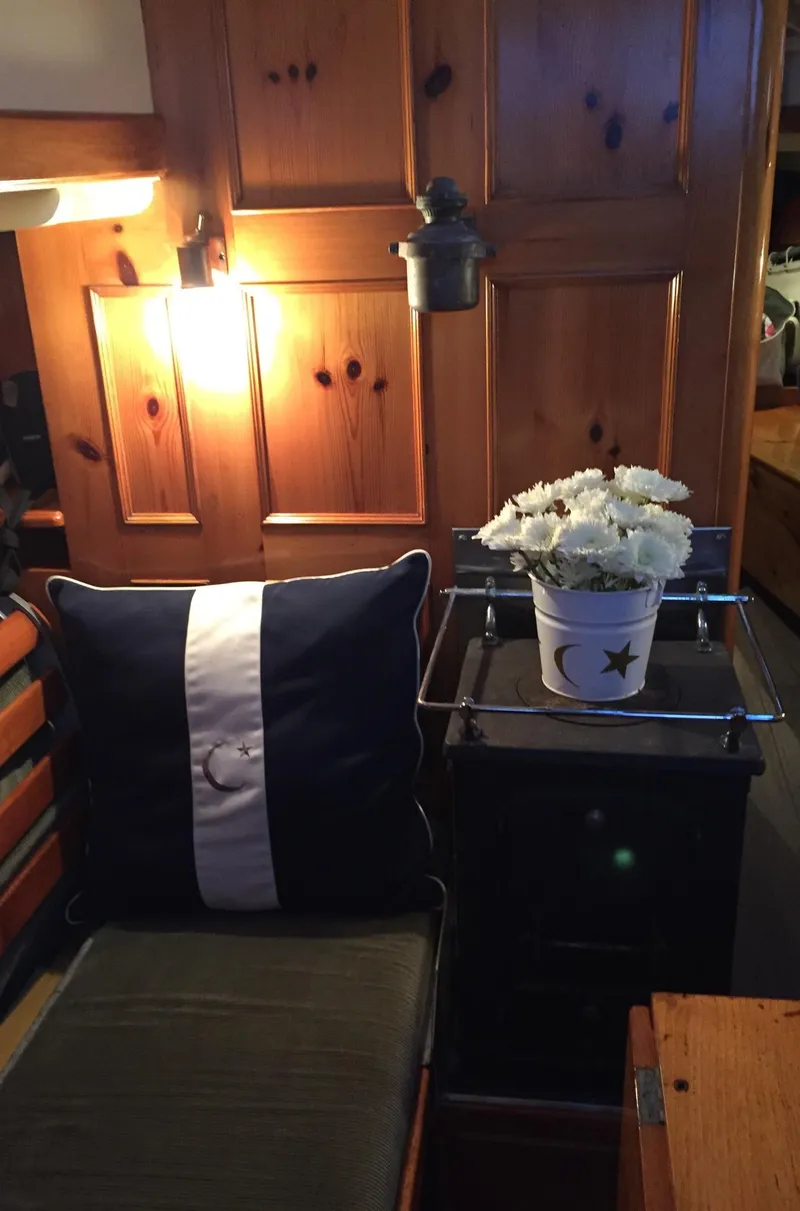 Slide: The Image of Cozy Concordia 39 yacht interior with cushion, flowers, and warm lighting, 1964 model. - 5