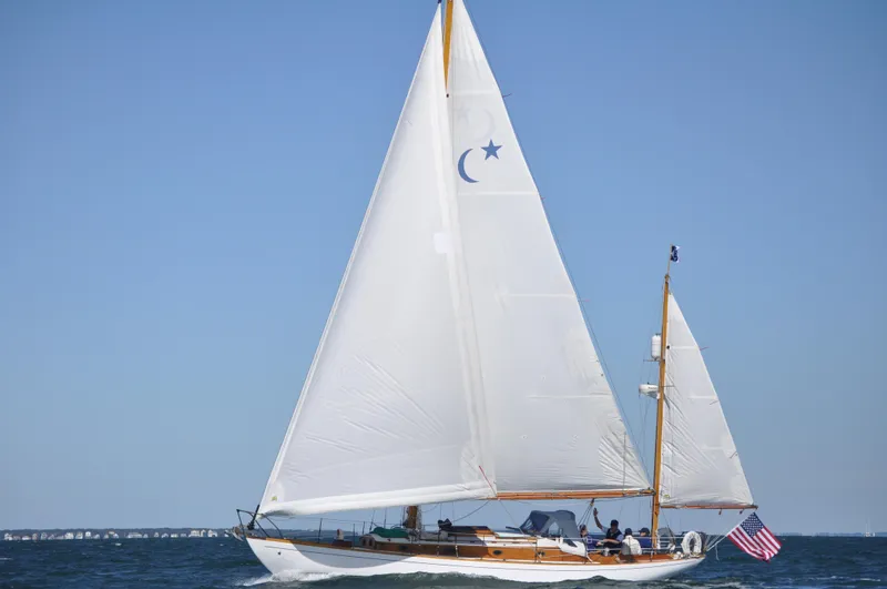 Slide: The Image of Vintage 1964 Concordia 39 sailboat with American flag, sailing on open water. - 9