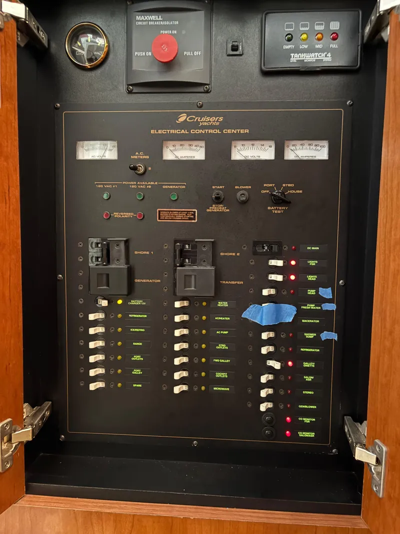 Slide: The Image of Electrical control panel of a 2001 Cruisers 3672 Express boat, featuring switches and gauges. - 10