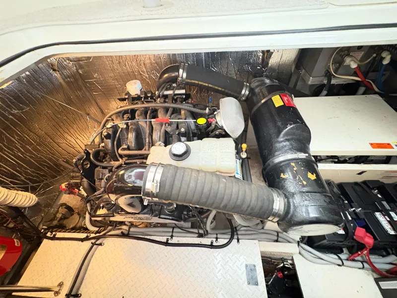 Slide: The Image of Engine compartment of a 2001 Cruisers 3672 Express boat, showcasing mechanical components. - 15