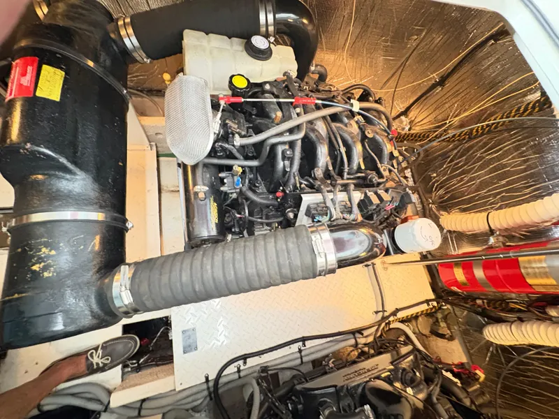 Slide: The Image of Engine room of a 2001 Cruisers 3672 Express boat, showcasing mechanical components. - 16
