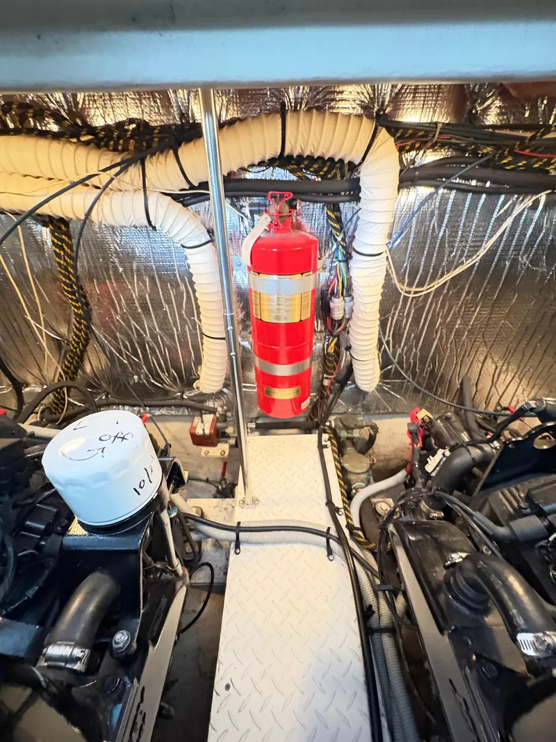 Slide: The Image of Engine room of 2001 Cruisers 3672 Express with fire extinguisher and mechanical components. - 18