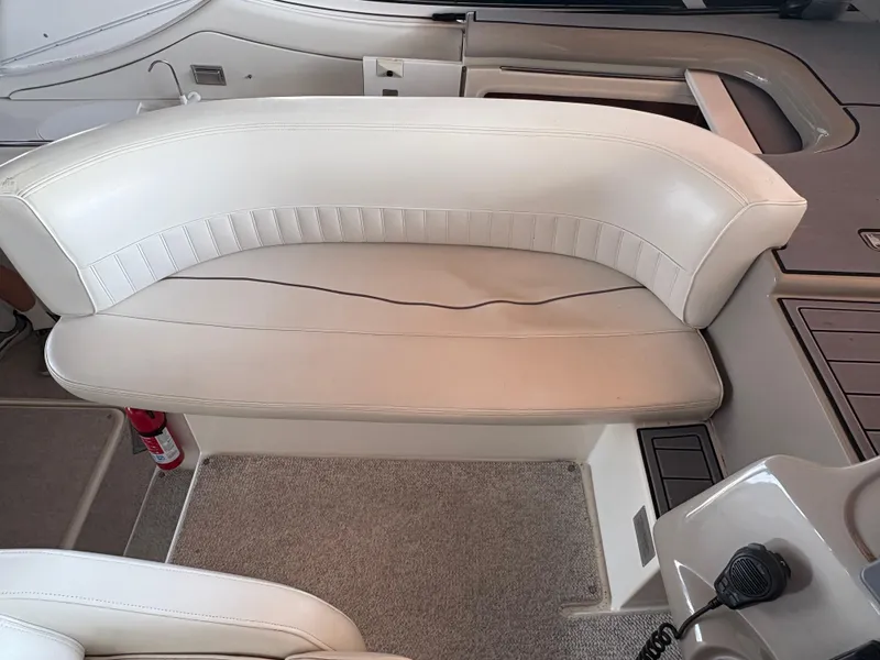 Slide: The Image of 2001 Cruisers 3672 Express boat interior with white seating and carpeted floor. - 3
