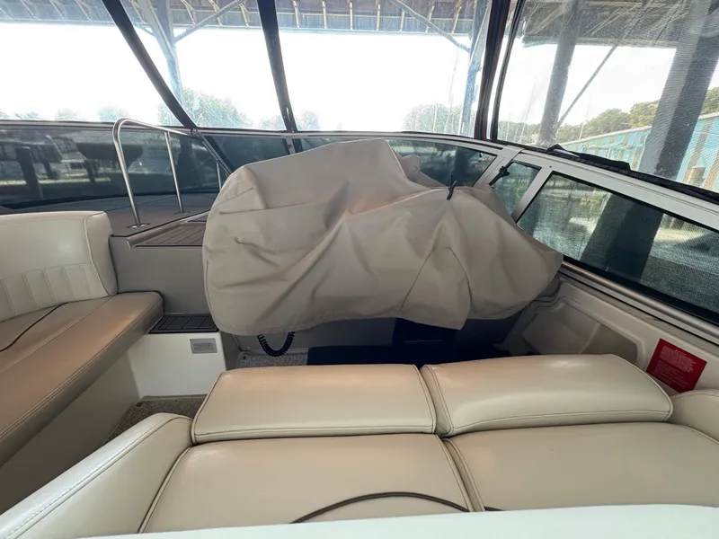 Slide: The Image of 2001 Cruisers 3672 Express boat interior with covered helm and white seating. - 4