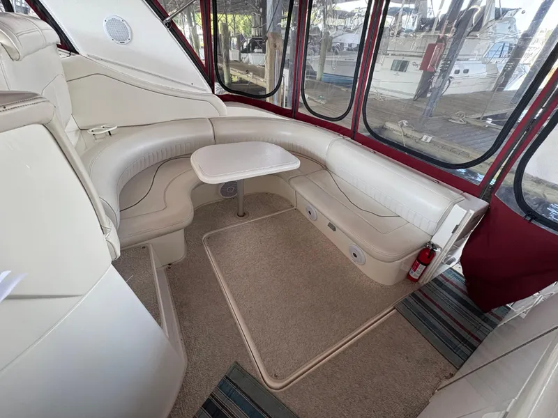 Slide: The Image of 2001 Cruisers 3672 Express interior with beige seating, small table, and large windows. - 6