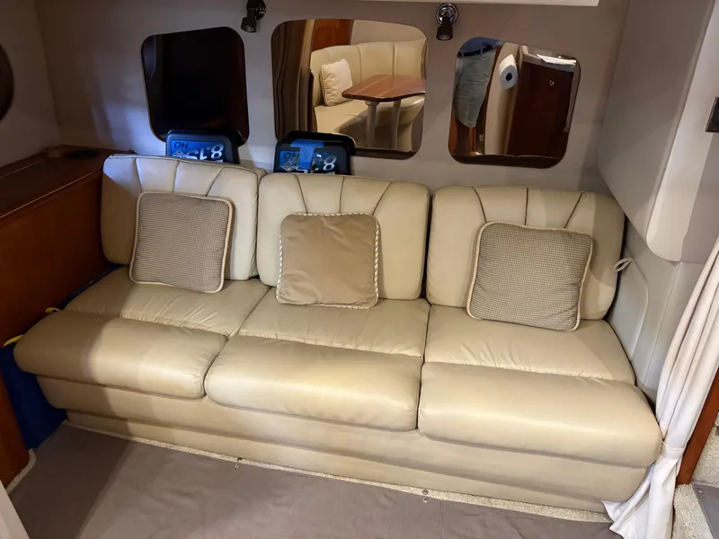 Slide: The Image of Beige leather sofa with cushions in a 2001 Cruisers 3672 Express yacht interior. - 9