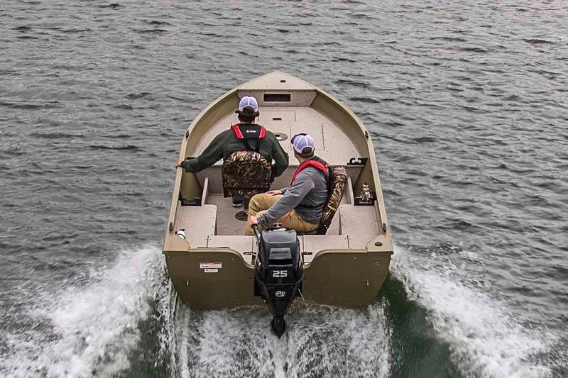 Slide: The Image of Manufacturer Provided Image: 2020 Crestliner 1450 Discovery Tiller boat on water with two passengers. - 14