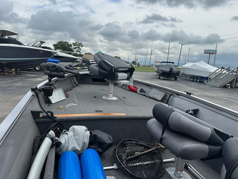 Slide: The Image of 2020 Crestliner 1450 Discovery Tiller boat interior with fishing gear and seating. - 4