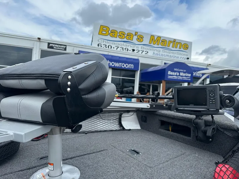 Slide: The Image of 2020 Crestliner 1450 Discovery Tiller boat at Basa's Marine showroom with folded seat and navigation equipment. - 7