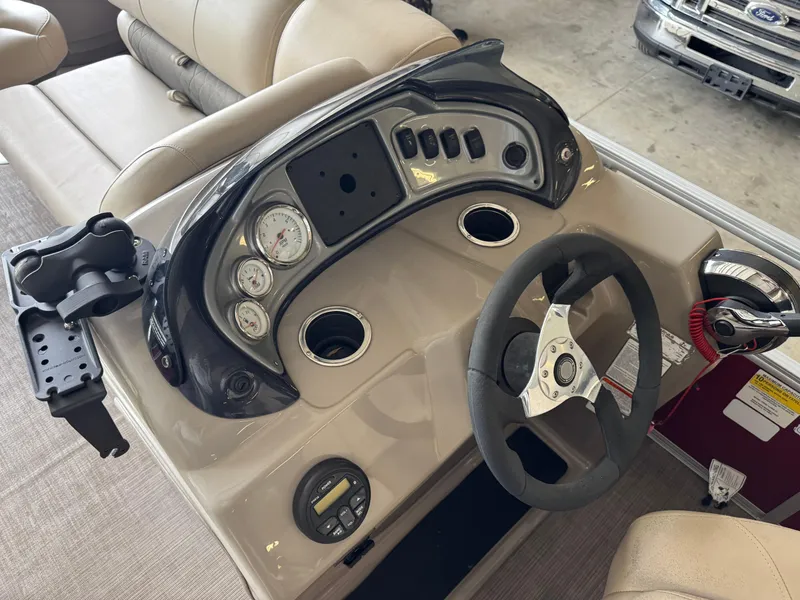 Slide: The Image of Dashboard of a 2021 Sun Tracker Fishin' Barge 20 DLX with steering wheel and gauges. - 11