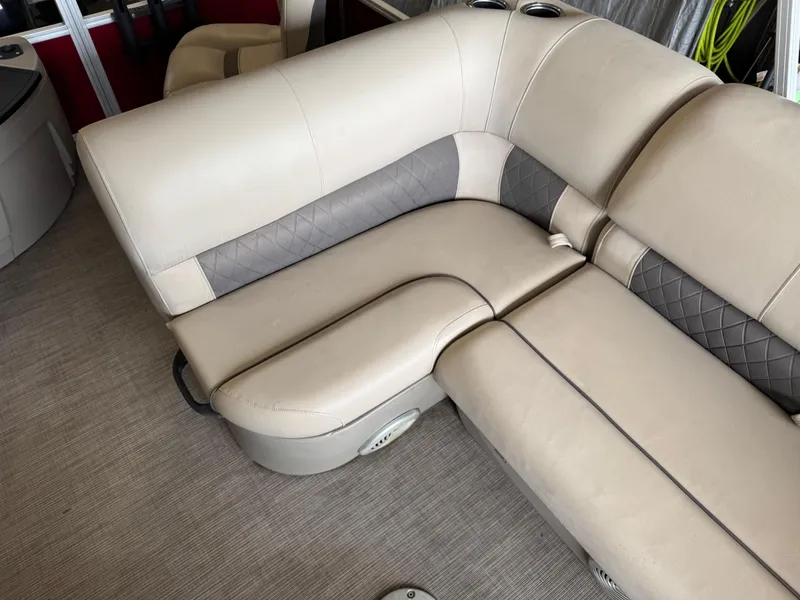 Slide: The Image of 2021 Sun Tracker Fishin' Barge 20 DLX interior seating with beige and gray upholstery. - 14