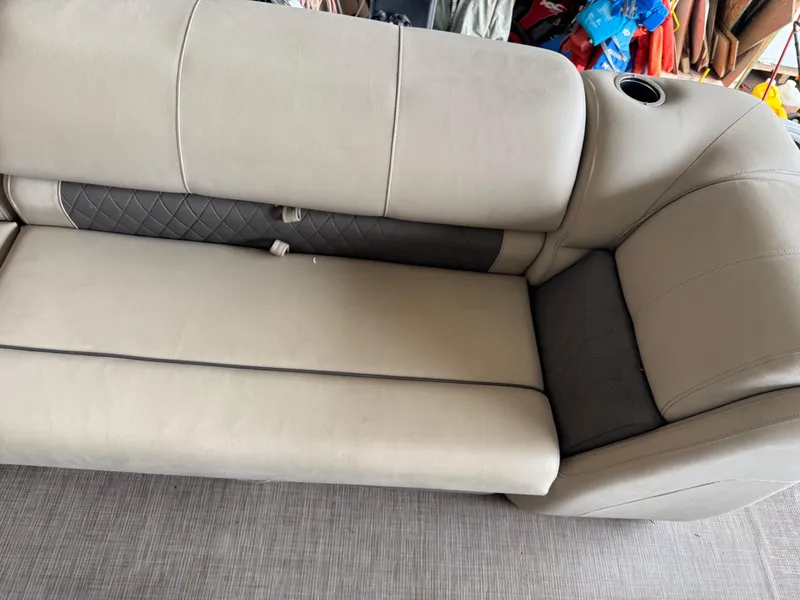 Slide: The Image of Beige seating on 2021 Sun Tracker Fishin' Barge 20 DLX boat, featuring cup holder. - 15