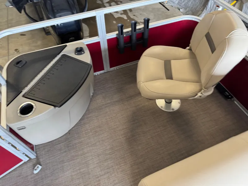 Slide: The Image of 2021 Sun Tracker Fishin' Barge 20 DLX interior with beige seating and fishing station. - 16