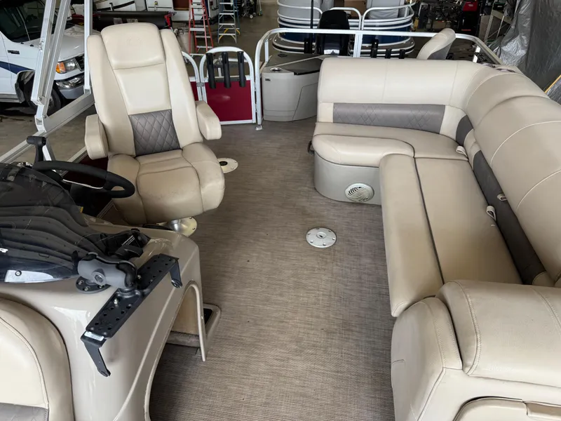 Slide: The Image of 2021 Sun Tracker Fishin' Barge 20 DLX interior with beige seating and steering console. - 6