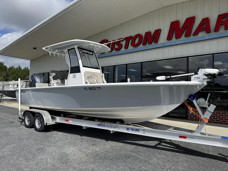 Slide: The Image of 2024 Sportsman Masters 247OE Bay Boat on trailer outside dealership. - 1