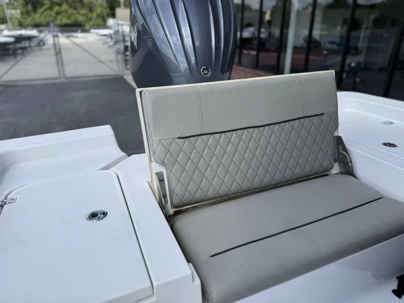 Slide: The Image of 2024 Sportsman Masters 247OE Bay Boat with gray cushioned seating and sleek design. - 12