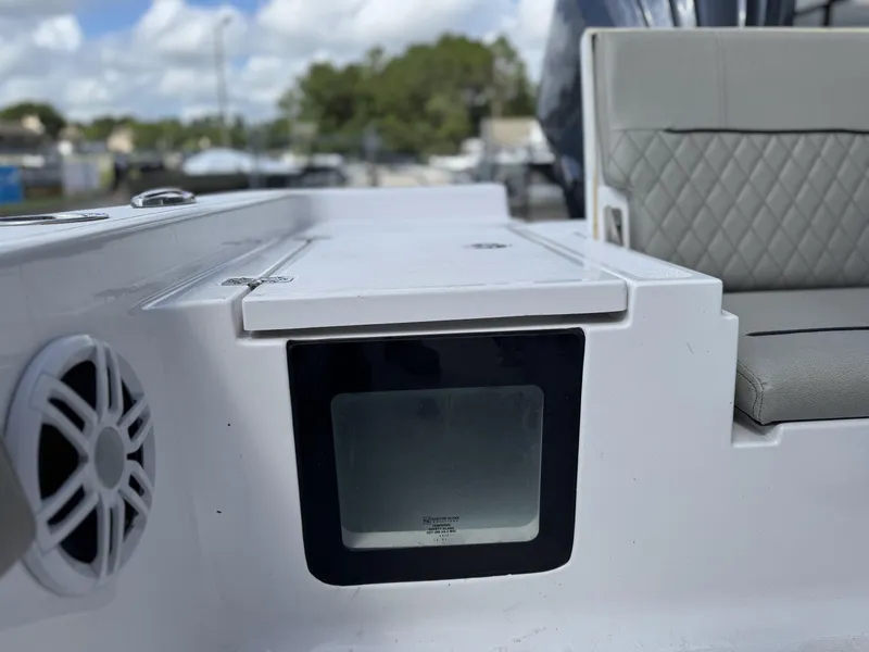 Slide: The Image of 2024 Sportsman Masters 247OE Bay Boat interior with speaker and cushioned seating. - 13