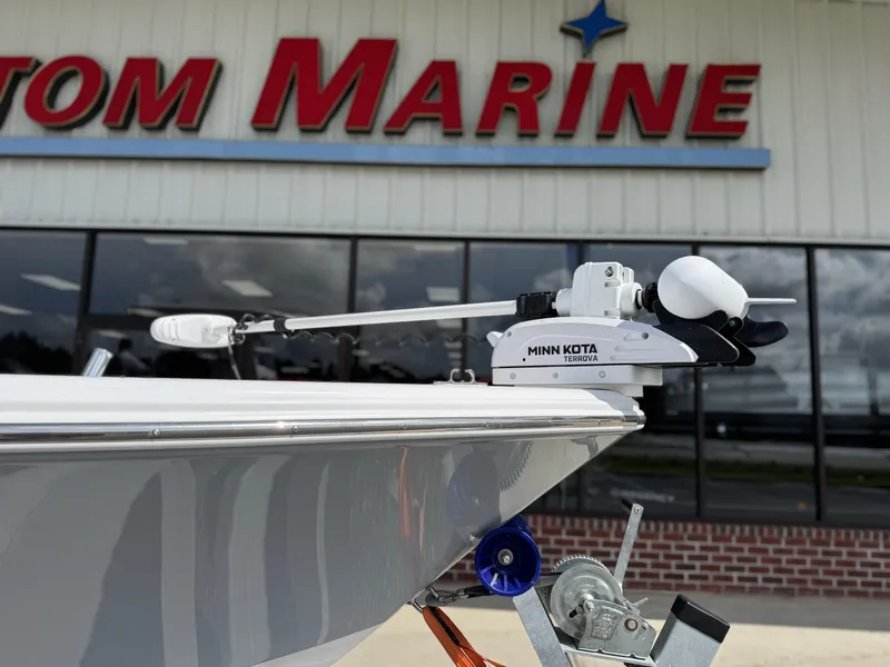 Slide: The Image of 2024 Sportsman Masters 247OE Bay Boat with Minn Kota Terrova motor at marine dealership. - 5