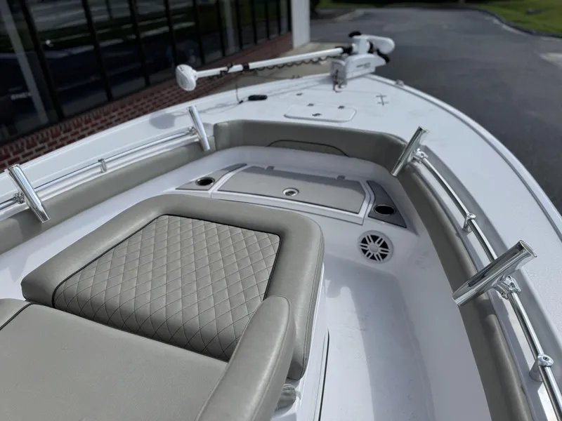Slide: The Image of 2024 Sportsman Masters 247OE Bay Boat interior with cushioned seating and stainless steel railings. - 7
