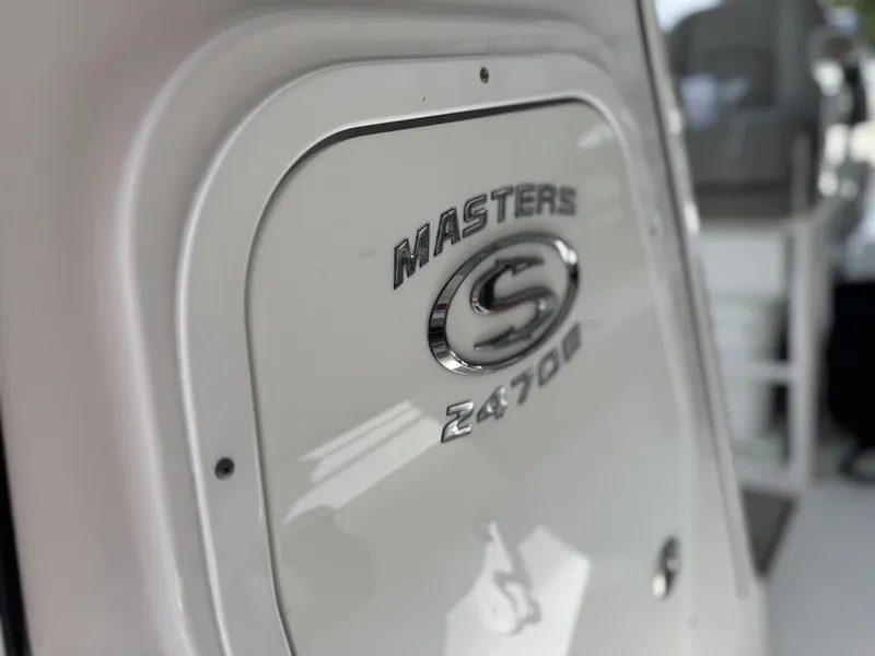 Slide: The Image of 2024 Sportsman Masters 247OE Bay Boat emblem on white surface. - 9