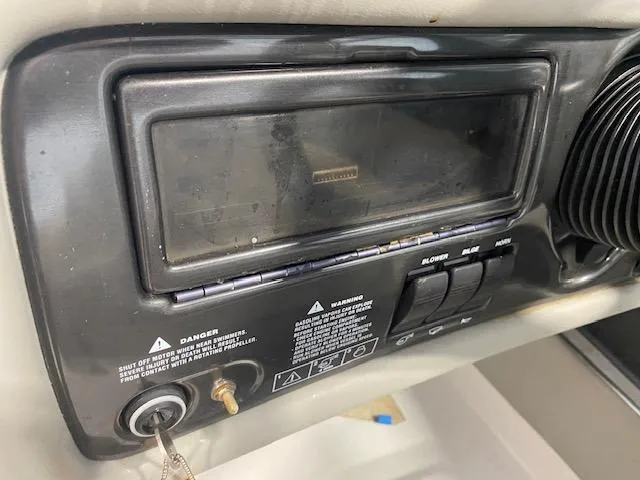 Slide: The Image of Dashboard of a 2000 Four Winns 200 Horizon boat with key ignition and controls. - 11