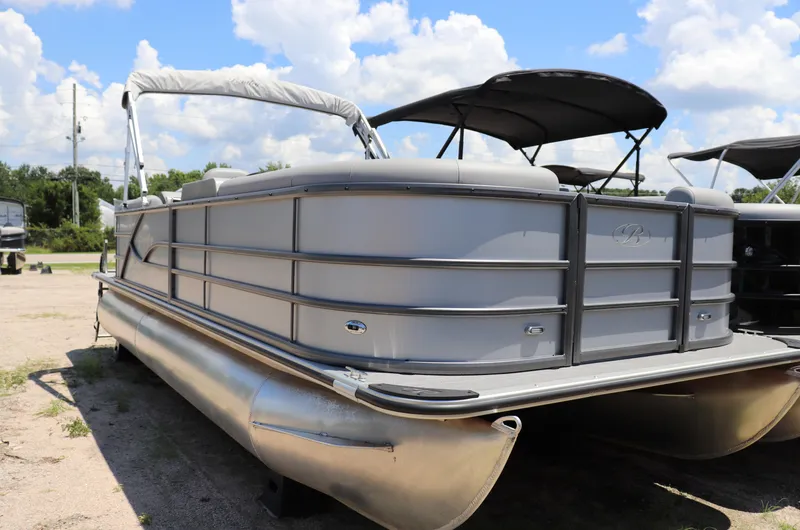 Slide: The Image of 2025 Bentley Pontoons 220 Navigator on display under a clear blue sky. - 0