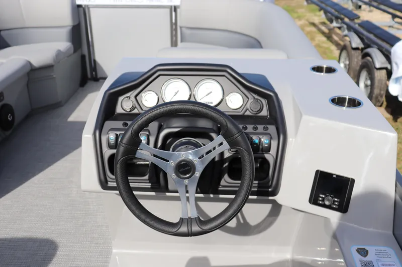 Slide: The Image of 2025 Bentley Pontoons 220 Navigator dashboard with steering wheel and control panel. - 4