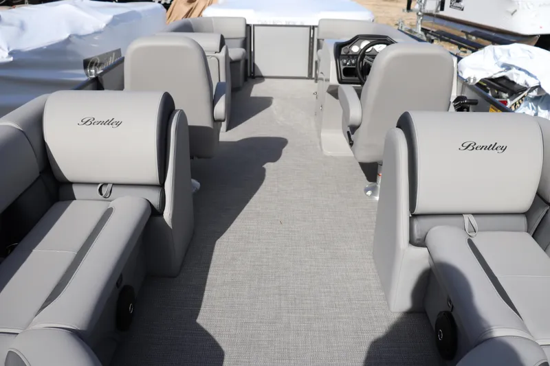Slide: The Image of 2025 Bentley Pontoons 220 Navigator interior with gray seating and steering console. - 8
