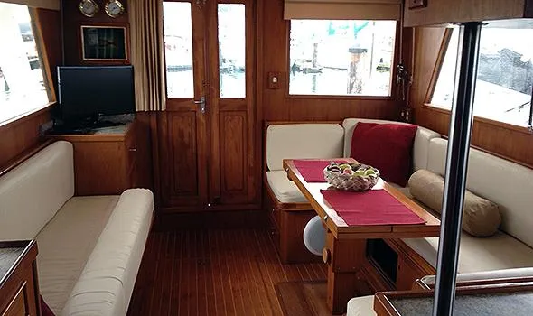 Slide: The Image of Interior of 1986 Sea Ranger 47 Pilothouse with cozy seating and wooden finishes. - 11