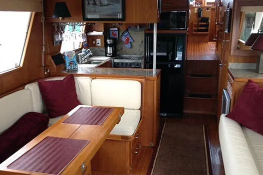 Slide: The Image of Interior of 1986 Sea Ranger 47 Pilothouse with cozy seating and wooden finishes. - 17