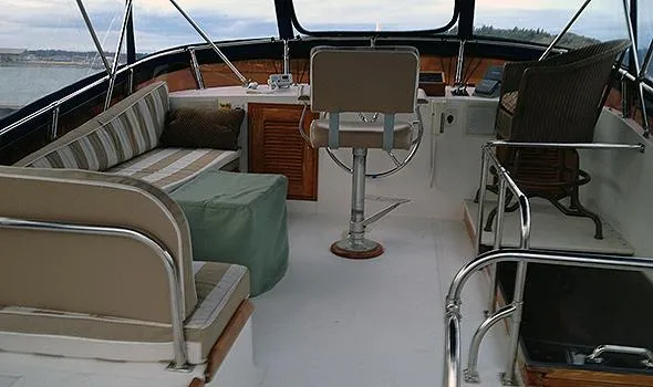 Slide: The Image of 1986 Sea Ranger 47 Pilothouse interior with seating and helm, showcasing nautical design. - 4