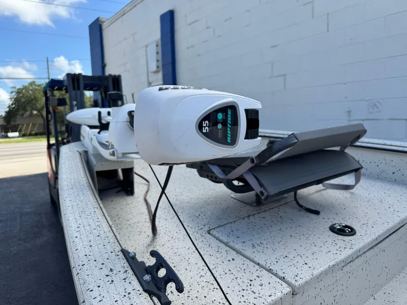 Slide: The Image of 2016 Xpress HD16DB boat with trolling motor, parked near a white building. - 3