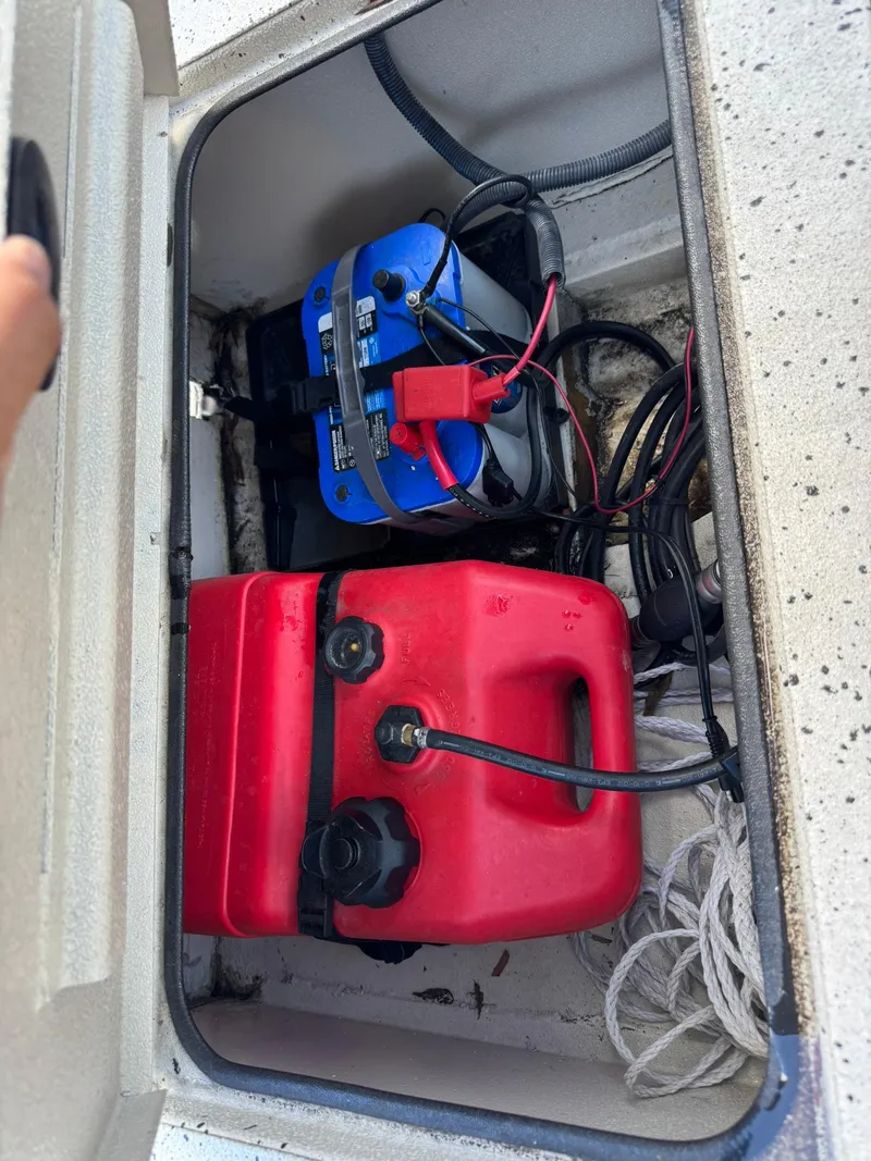 Slide: The Image of Boat storage compartment with battery and red fuel tank, Xpress HD16DB 2016 model. - 7