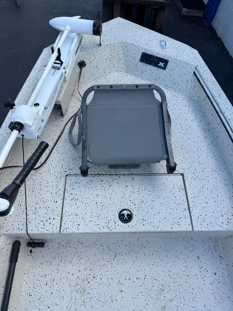 Slide: The Image of 2016 Xpress HD16DB boat interior with speckled deck and mounted trolling motor. - 9