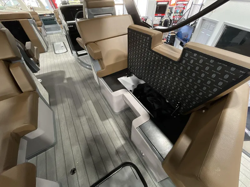 Slide: The Image of Interior of 2025 Balise Horizon 26C boat with tan seating and storage compartments. - 13
