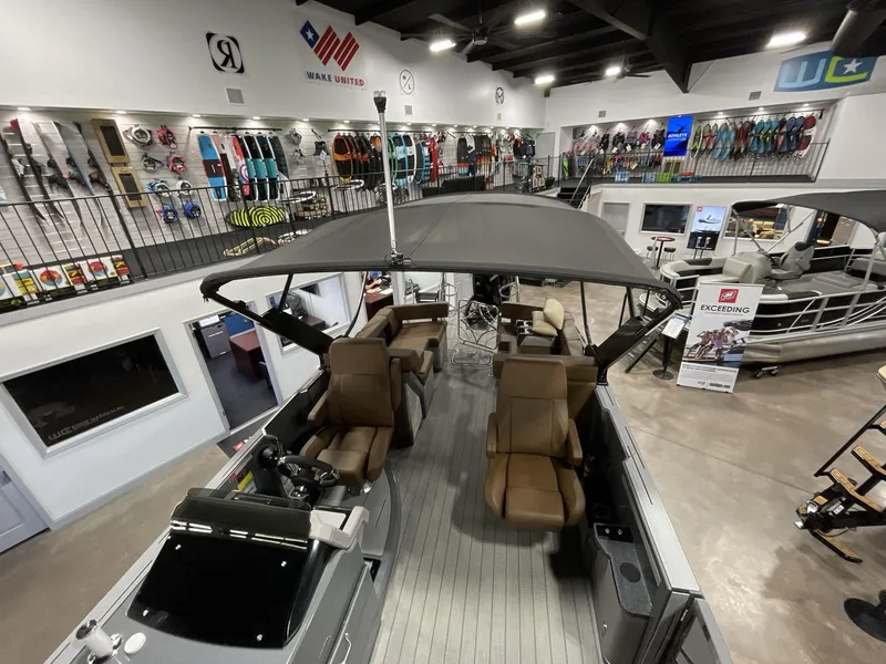 Slide: The Image of 2025 Balise Horizon 26C boat displayed in a showroom with water sports equipment. - 15