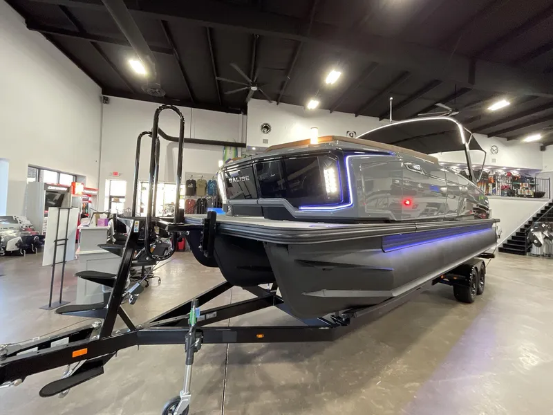 Slide: The Image of 2025 Balise Horizon 26C boat displayed indoors on a trailer. - 2