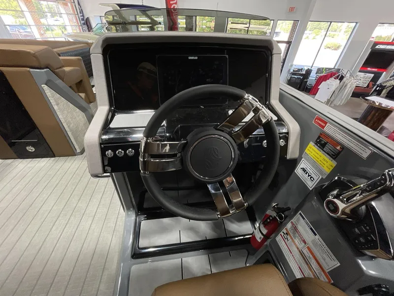Slide: The Image of Steering console of 2025 Balise Horizon 26C boat, featuring modern controls and dashboard. - 22